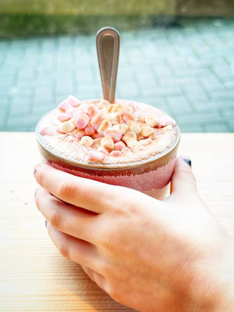 istock Child’s hand holding a marshmallow covered hot chocolate 1998077146