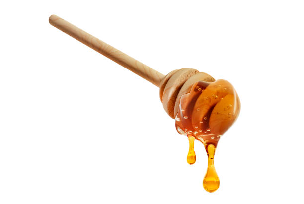 istock Wooden honey dipper with honey 1998084360