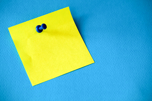 Yellow Post-its on Blue Background, Empty Text Area Reminder