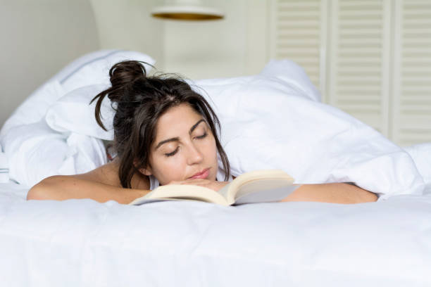 Woman  reading book in the bed