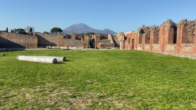 Old sanctuary in Pompeii with Vesuvius volcano in background.