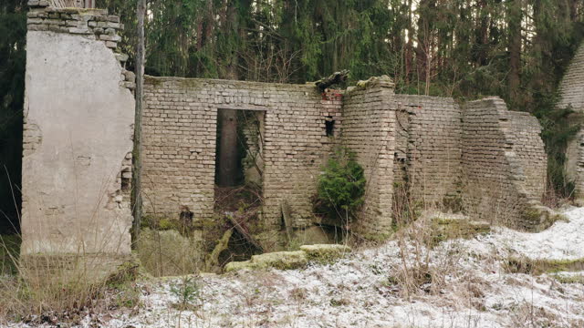 Old ruined brick house in remote wild green countryside