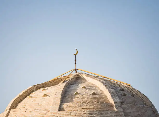 Photo of Brick dome of an ancient mosque in the morning at dawn in the ancient city of Bukhara in Uzbekistan, roof made of brick