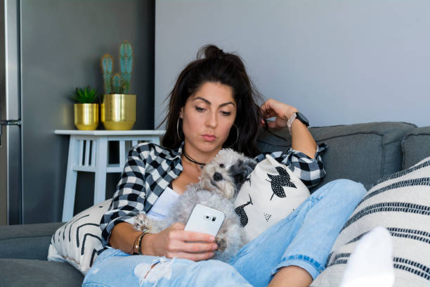 istock Sad Woman  using her phone at home 1998144761