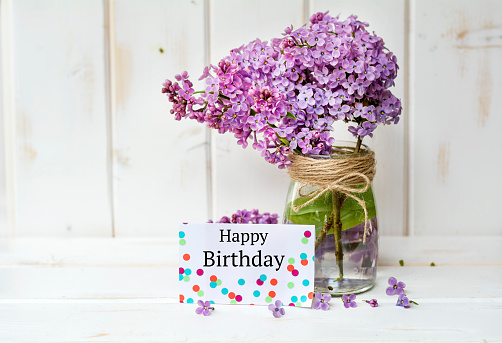 Happy birthday greeting card with lilac flowers
