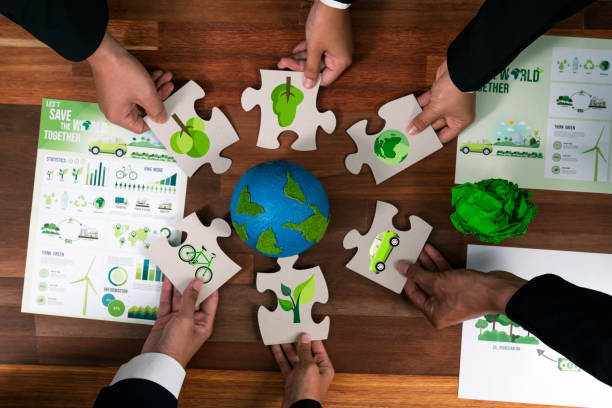 cohesive group of business people holding eco icon jigsaw puzzle. quaint - 지구 온난화 뉴스 사진 이미지