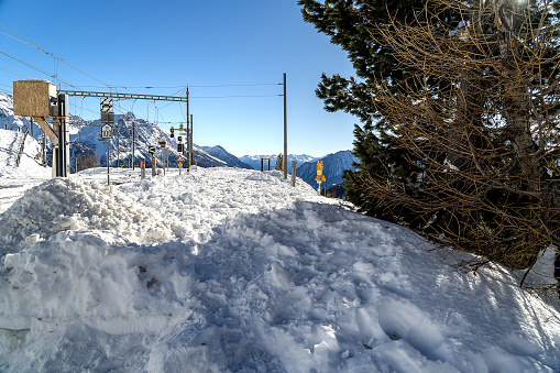 in the Swiss Alps. In the foreground heap of snow