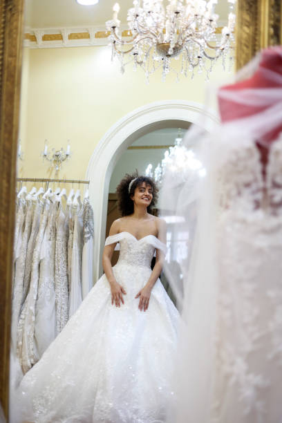 istock Young woman trying on a wedding dress 1998212549