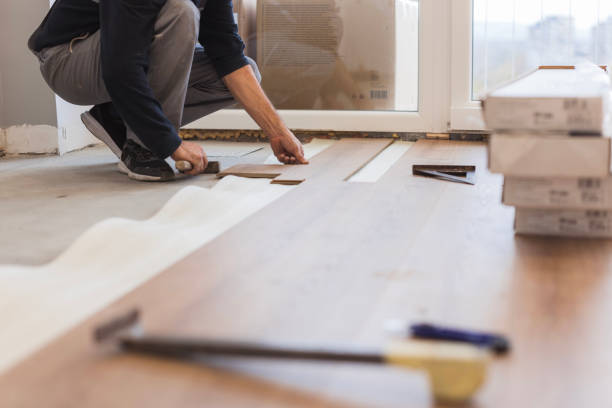 istock Man using hammer when positioning hardwood floor tiles 1998217769