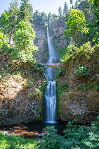 A long exposure photo of Multnomah falls from the base of the falls.