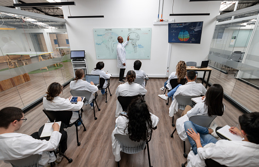 Group of young students listening to the girl