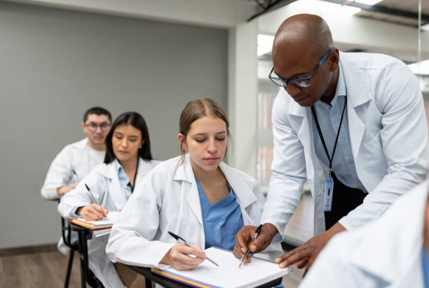 istock Medical professor helping a student in class 1998218486