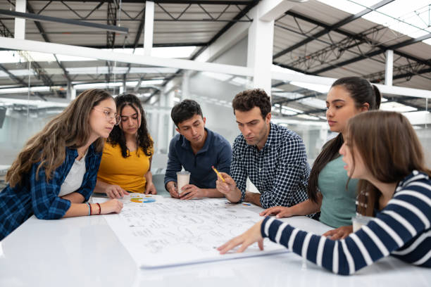 istock Teacher talking to a group of students in the classroom 1998218848
