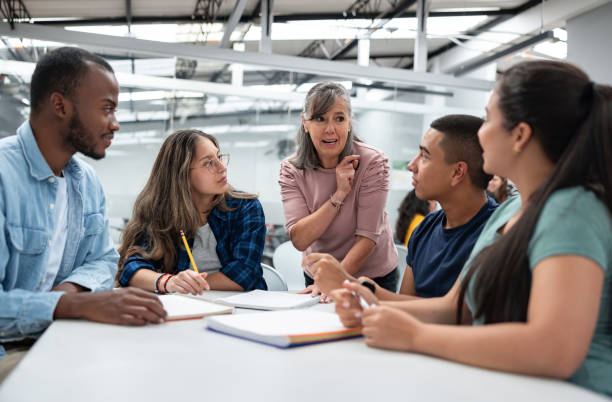 istock Teacher talking to a group of students in the classroom 1998218861
