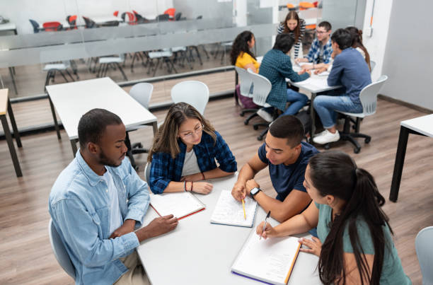 istock Group of students sharing ideas in a classroom 1998218874