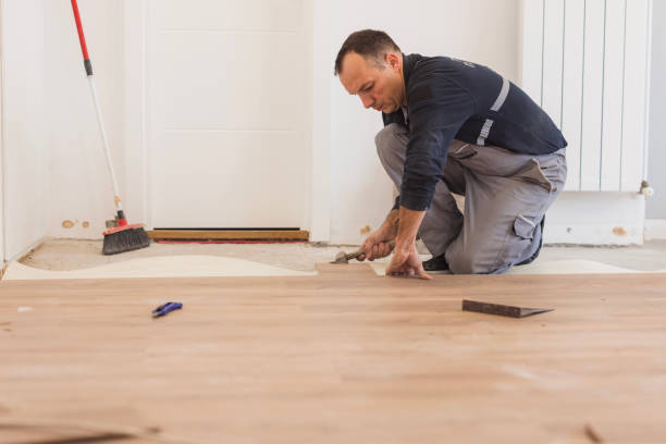 istock Man using hammer when positioning hardwood floor tiles 1998220446