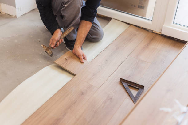 istock Man using hammer when positioning hardwood floor tiles 1998220970