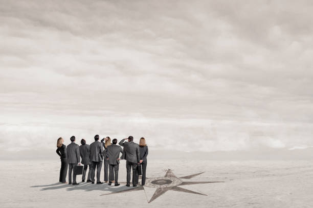 istock Group Of Business People Standing Next To Compass Search For Direction 1998233565