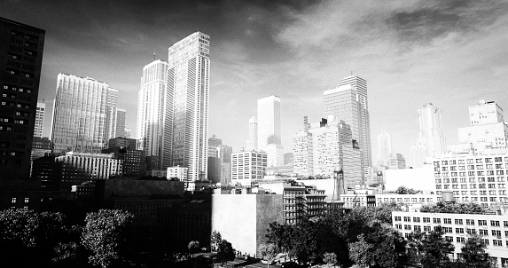 Digitally generated American style city on a sunny morning, in a noir manner.\n\nThe scene was created in Autodesk® 3ds Max 2024 with V-Ray 6 and rendered with photorealistic shaders and lighting in Chaos® Vantage with some post-production added.