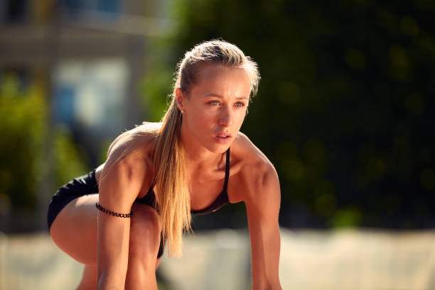 Pilates instructor doing healthy sports in the garden, on the grass