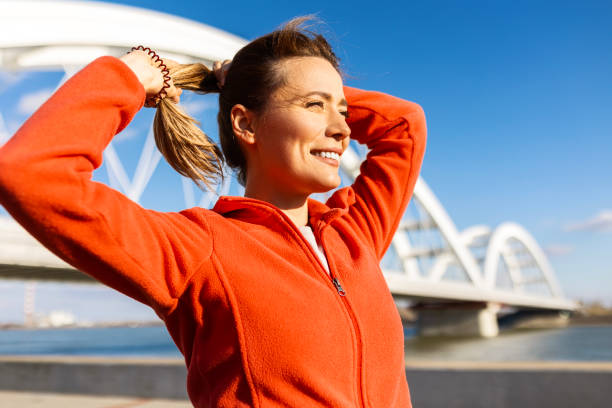 Happy sportswoman jogging at the riverfront