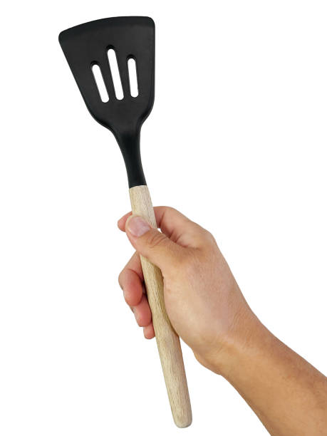 istock Isolated hand holding a wooden Slotted Turner 1998262528
