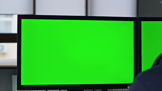 Closeup chromakey screen in office. It manager working on template computer programming software at workplace. Unrecognized designer engineer creat project on mockup pc. Data cyber security service