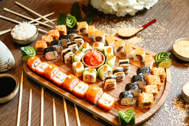 istock Wooden Plate With Sushi and Chopsticks 1998282231