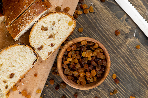 sweet wheat bun with raisins on the table, sweet bun with golden raisins