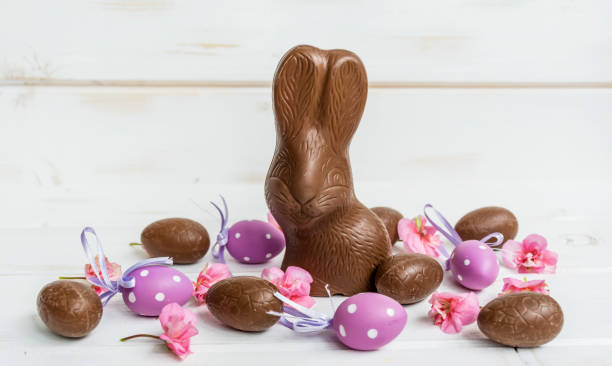 Colorful flowers and Easter eggs on a beautiful background. Easter themed background, frame and poster.
