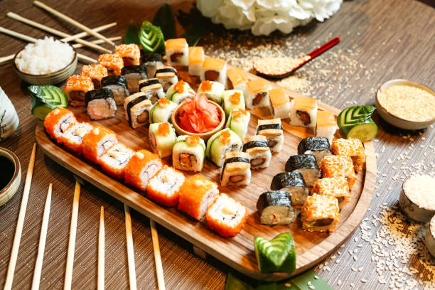 istock Wooden Platter Filled With Sushi and Chopsticks 1998307886