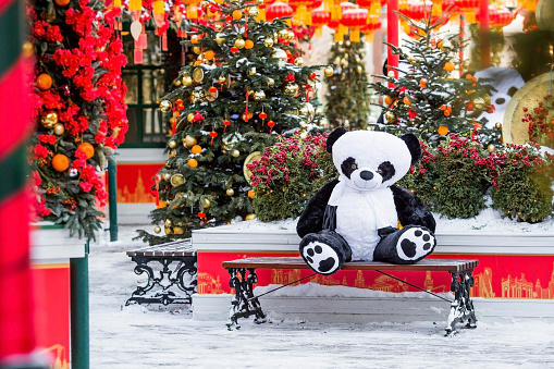 Plush stuffed pandas and Chinese red Christmas lanterns on Tverskaya Street in Moscow. Close-up. The first ever meeting of the Chinese New Year 2024 in Moscow.