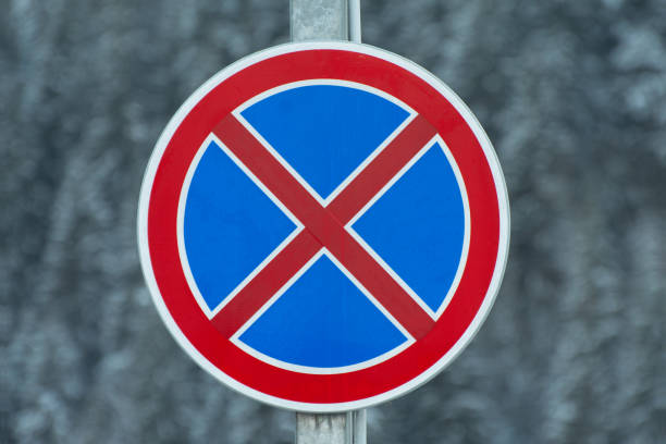 Road sign on a pole. Stopping is prohibited.