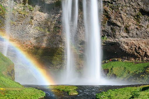 The waterfall Seljalandsfoss with a rainbow, famous landmark in southern Iceland