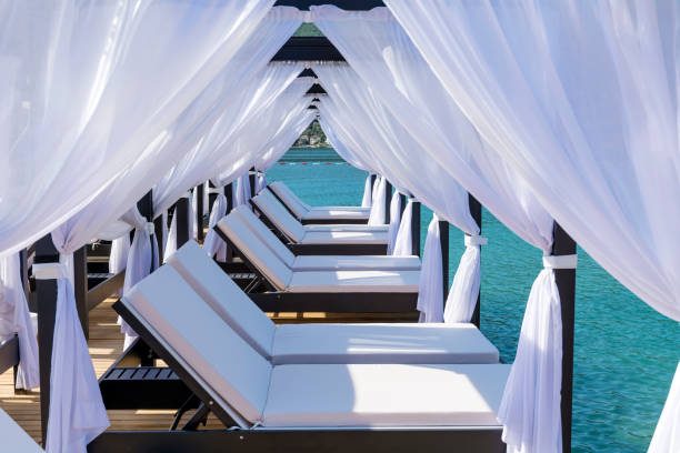 White beach canopies. Luxury beach tents at a resort. Beach holidays concept