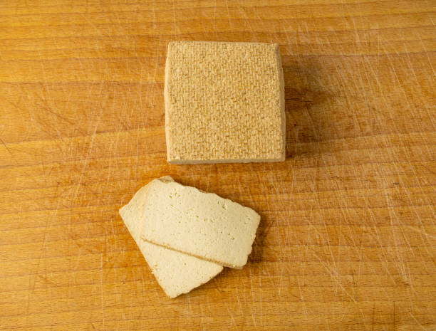 Tofu Cheese Isolated, Smoked Vegan Cheese Slice, Sliced Soya Bean Curd, Soy Protein or TSP Tofu Cheese Block, Smoked Vegan Cheese Slice, Sliced Soya Bean Curd, Soy Protein or TSP Healthy Meat Analogue, Tofu Cheese on Wooden Cutting Board Background tsp stock pictures, royalty-free photos & images