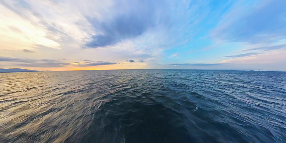 Sunset over the ocean in a cloudy sky