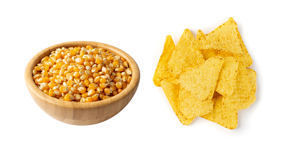 Heap of triangle corn chips isolated on white background. Mexican nachos chips for nacho tortilla, maize snack, corn crisps or totopos