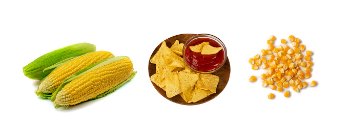 Heap of triangle corn chips on wood plate with red sauce isolated on white background. Mexican nachos chips for nacho tortilla, maize snack, corn crisps or totopos with salsa dip