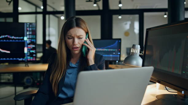 istock Stock trader working office ending phone call. Pensive woman analyse statistics 1998409466
