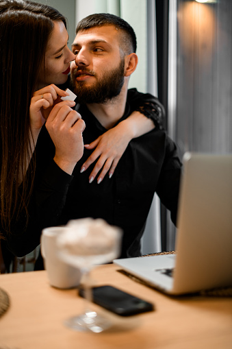workday romance blossoms as the girl captivates the guy with a kiss, providing a delightful and welcome distraction from his tasks.