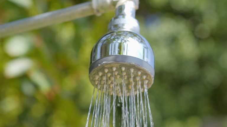 Chrome shower head with water streaming down in 4k slow motion 120fps