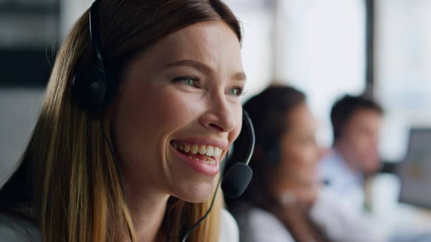 istock Joyful agent speaking headset closeup. Smiling woman professional talking client 1998416273
