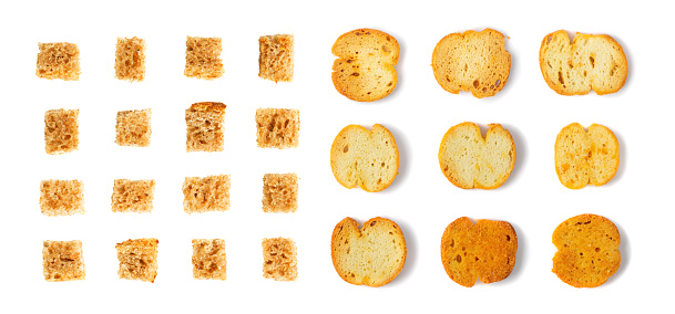 Set of homemade rye bread croutons isolated on white background top view. Crispy bread cubes collection, dry rye crumbs, rusks, crouoton or brown roasted crackers cube pattern
