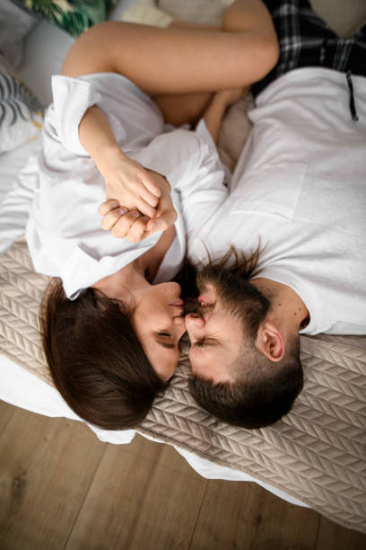istock Love's Awakening. Couple greets Valentine's morning with shared joy in bed. 1998423384