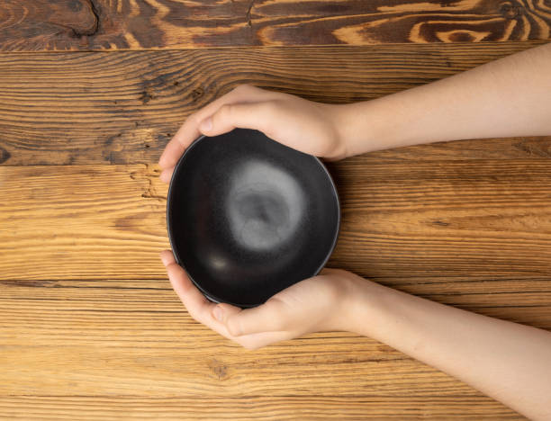 istock Bowl in Hands, Empty Bowl in Arms on Wooden Background, Vintage Kitchen Tableware Mockup 1998435852