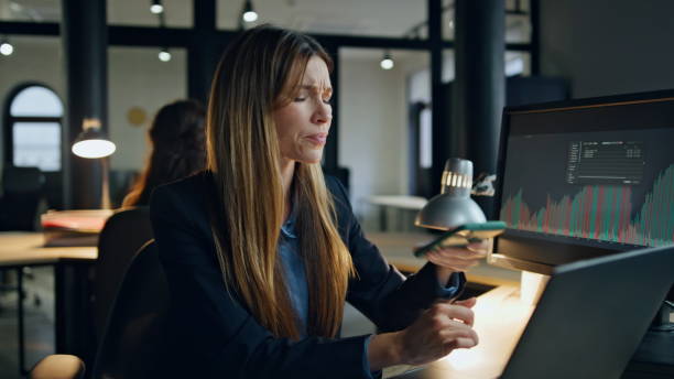 istock Stressed employee end call working late. Overwhelmed businesswoman think problem 1998452176