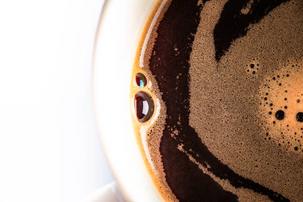 istock High angle view of bubbles in cup of black coffee 1998468492