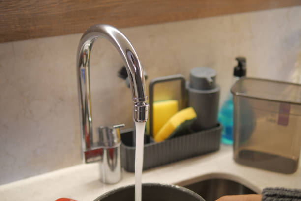 istock water pouring from a faucet tap slow motion 1998470648
