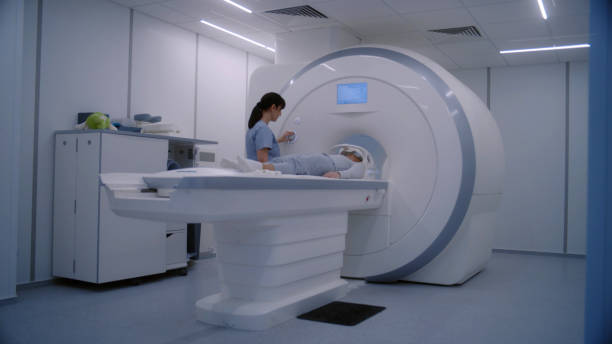 istock Female radiologist controls MRI or CT scan machine for female patient 1998495032